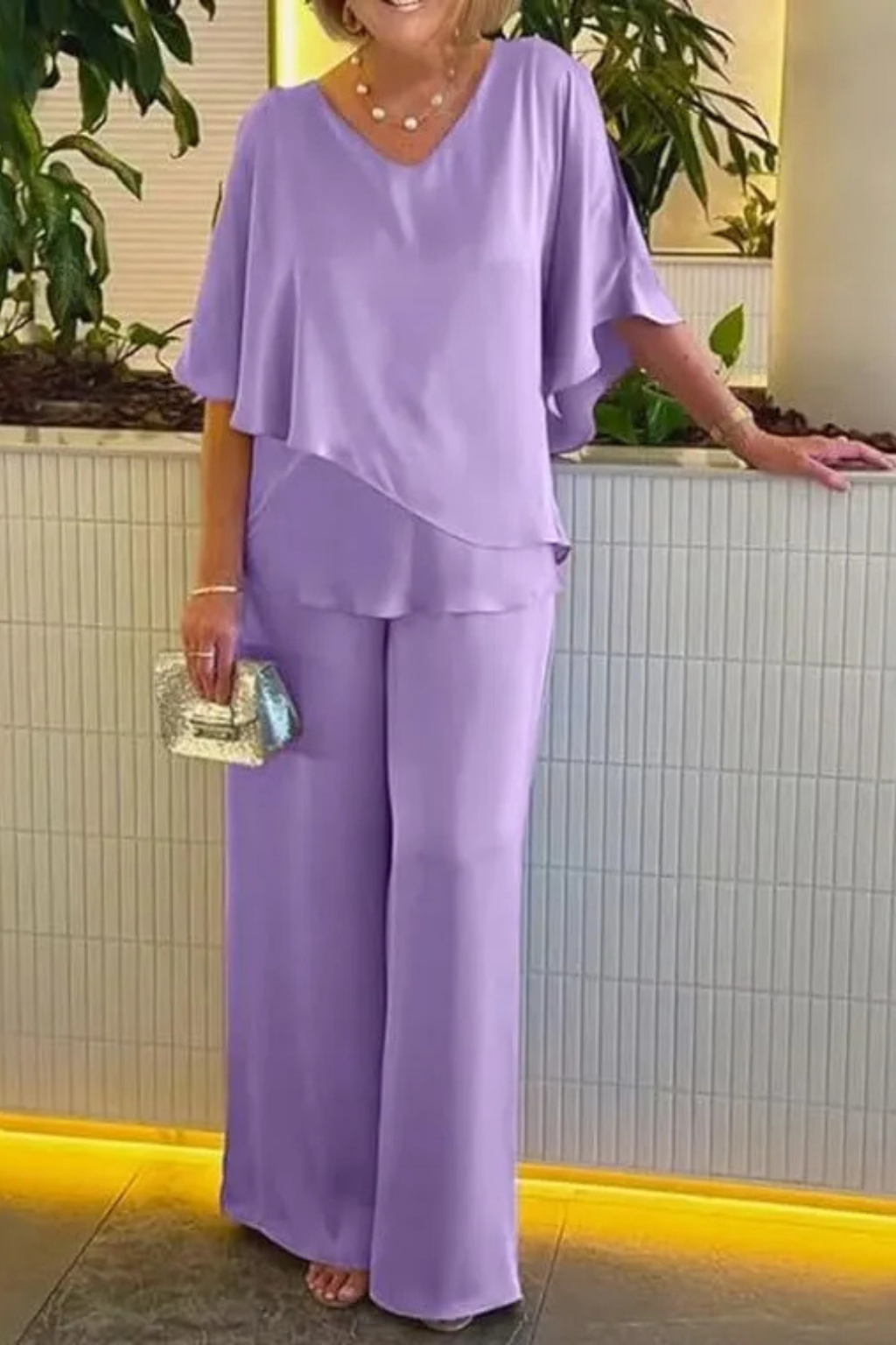 Elegant women's coordinated batwing top and wide-leg trousers. Ideal for a chic, relaxed look.
