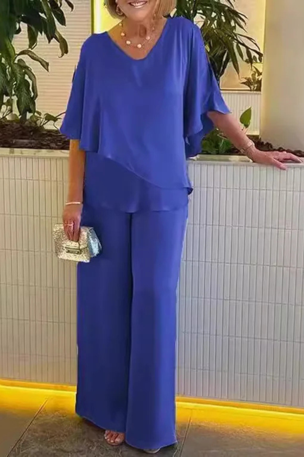 Elegant batwing sleeve top and wide leg trousers set for women. A chic and relaxed summer outfit.