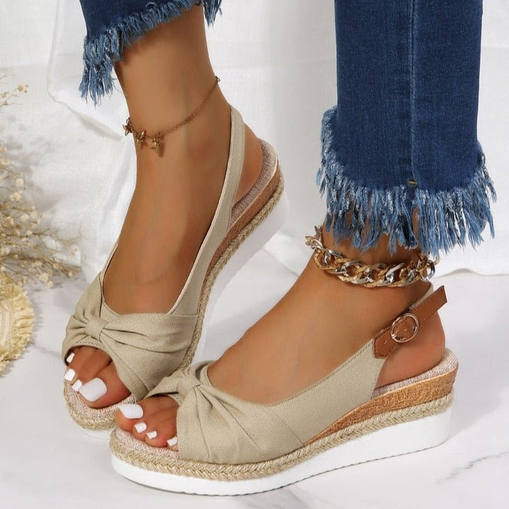 Fashionable women's summer wedge sandals featuring a stylish knot detail, open toe, and secure slingback strap.