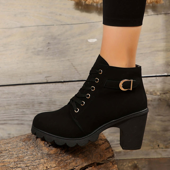 Women's stylish block heel ankle boots with chic buckle & convenient zipper. Modern fashion design.
