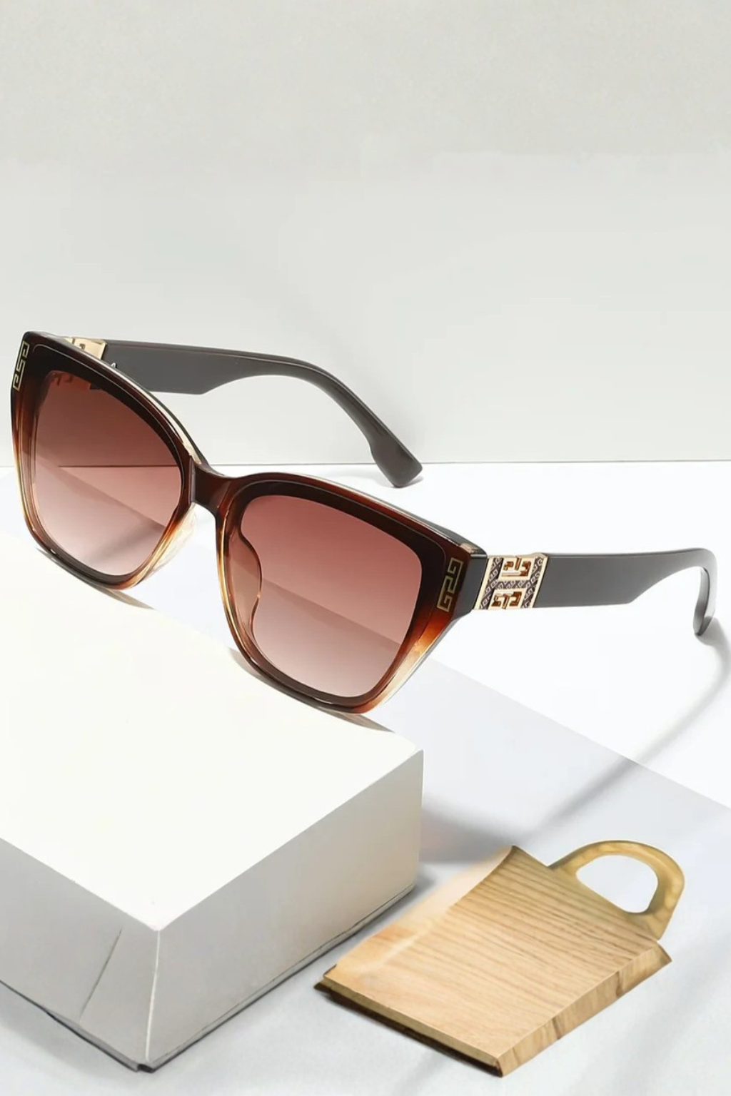 Fashionable women's cat eye sunglasses, gradient lenses & stylish gold accents.