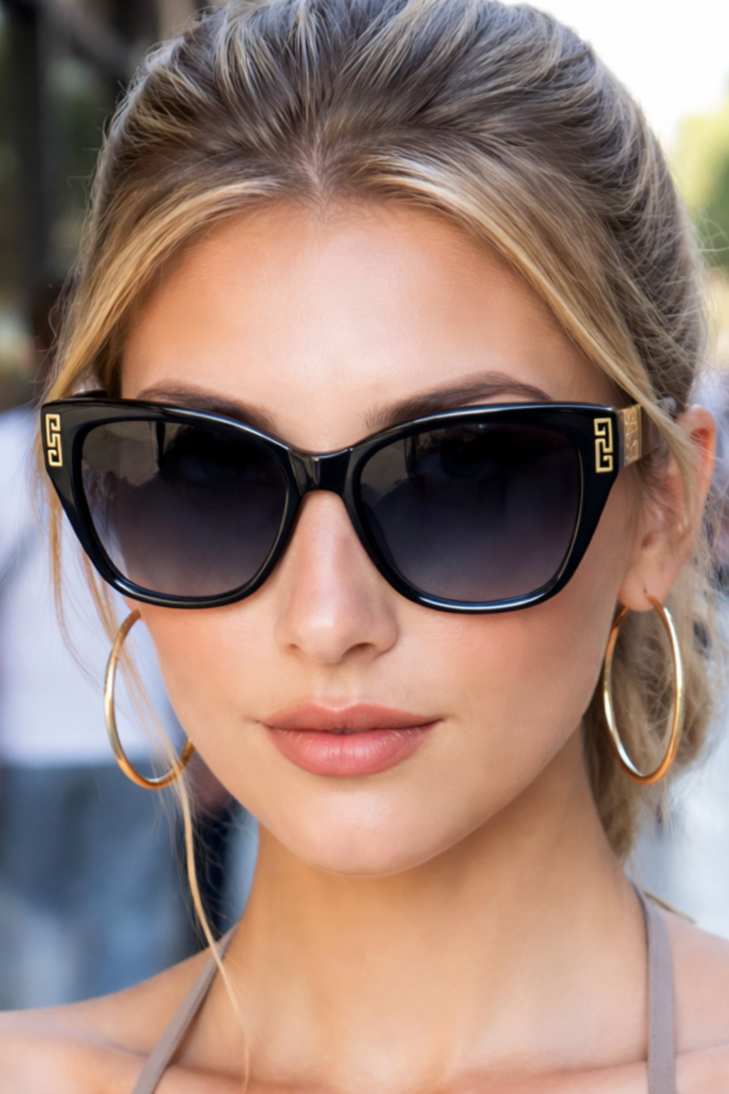 Elegant women's cat eye sunglasses, featuring sleek design and prominent gold accents.