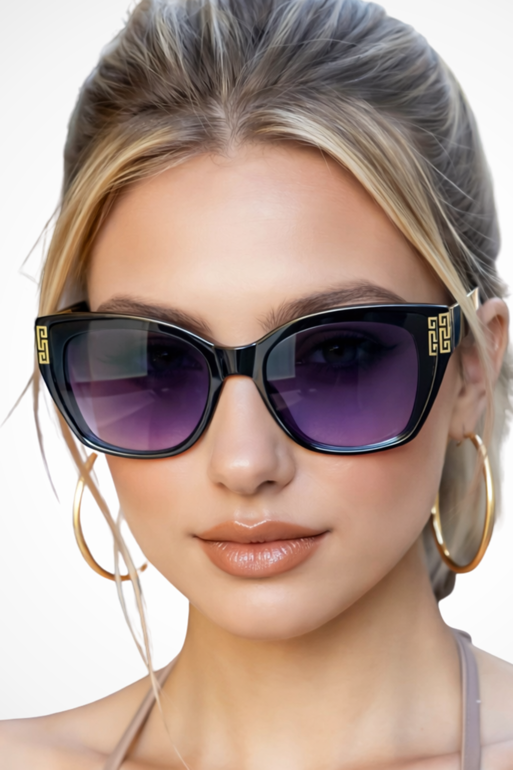 Close-up of women's cat eye sunglasses, highlighting intricate gold detail on the frames.