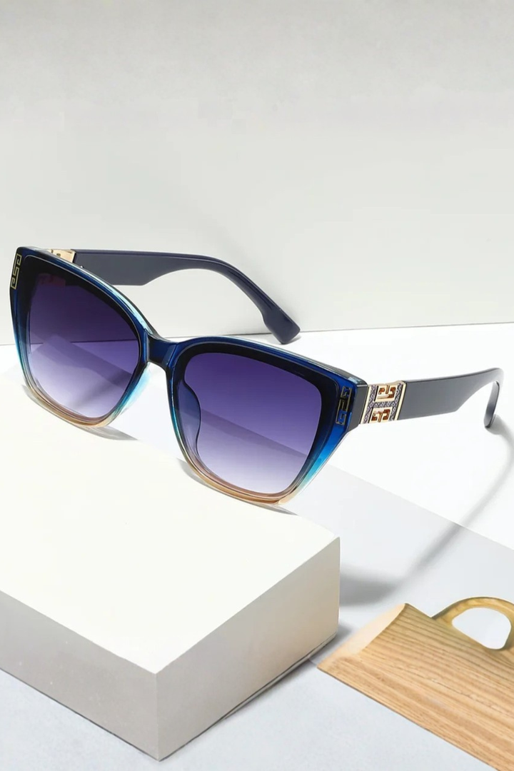 Black cat eye women's sunglasses with shiny gold accents, very chic and stylish eyewear.