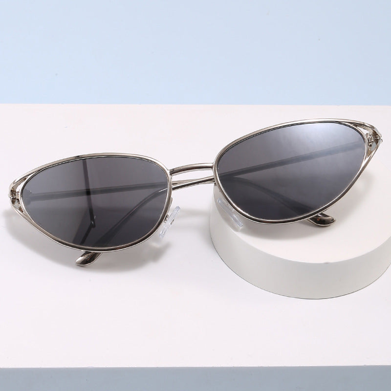 Women's chic cat-eye sunglasses with sleek metallic frame, offering stylish UV protection.