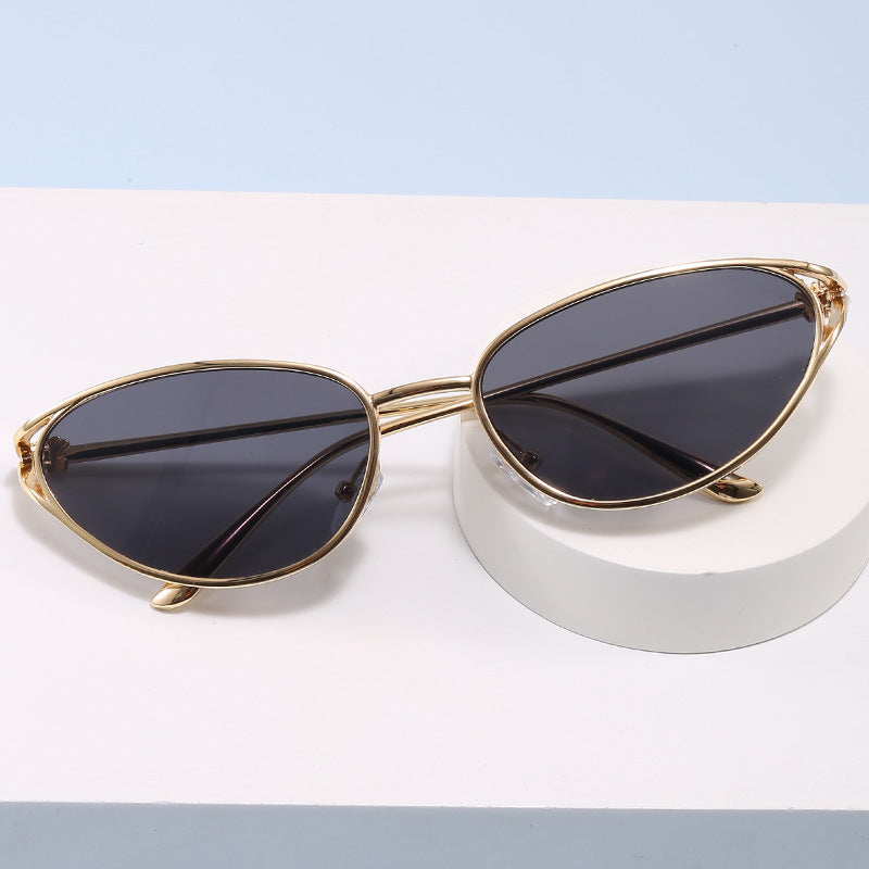 Elegant cat-eye sunglasses for women, featuring a sophisticated metallic frame & UV protection.