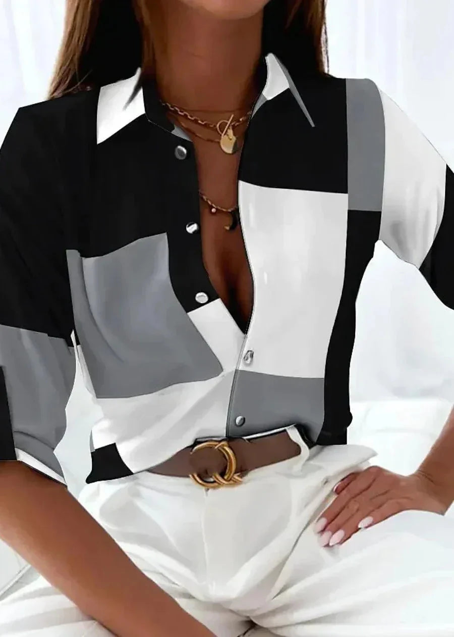 Casual chic women's color-block printed blouse. Features a collared, button-down front & comfortable 3/4 sleeves.