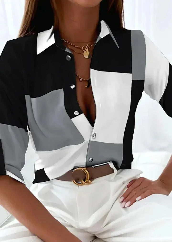 Casual chic women's color-block printed blouse. Features a collared, button-down front & comfortable 3/4 sleeves.