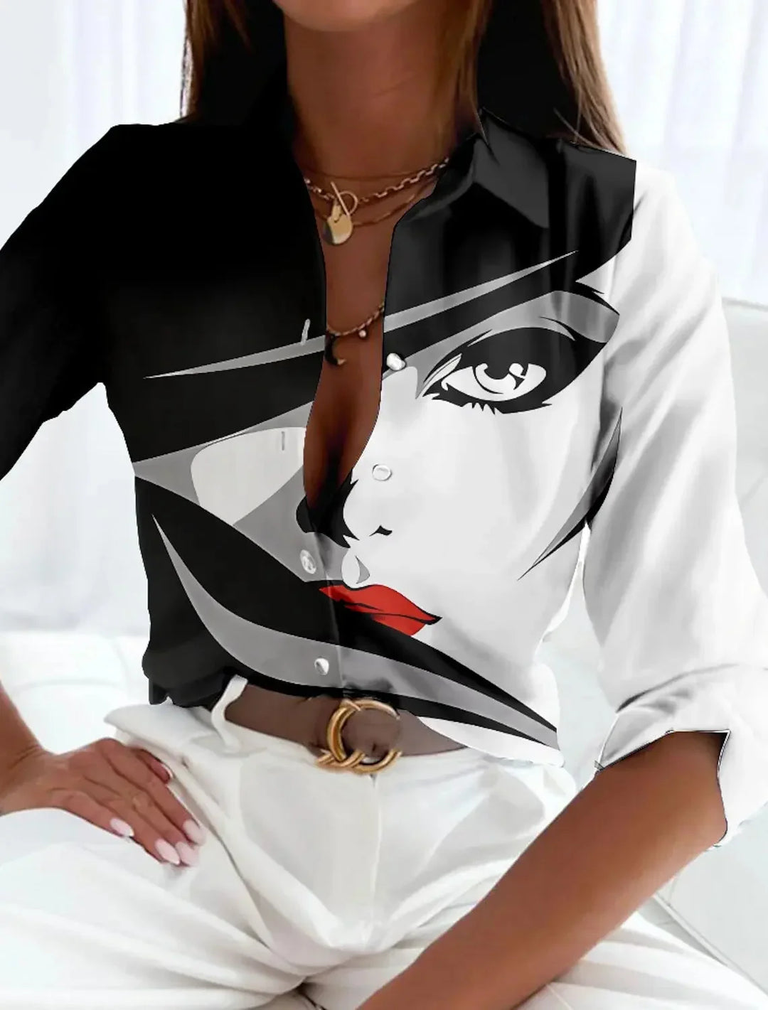 Elegant women's blouse with a vibrant color-block print, collared design, and stylish 3/4 sleeves. Casual chic top.