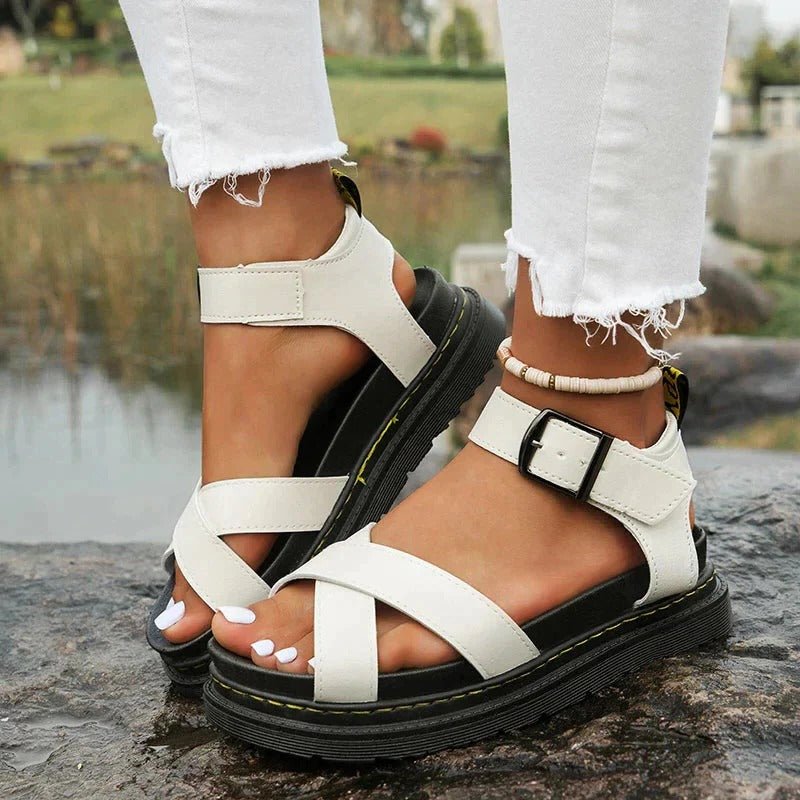 Comfortable women's cross-strap platform sandals featuring a thick sole & secure ankle buckle, ideal for summer.