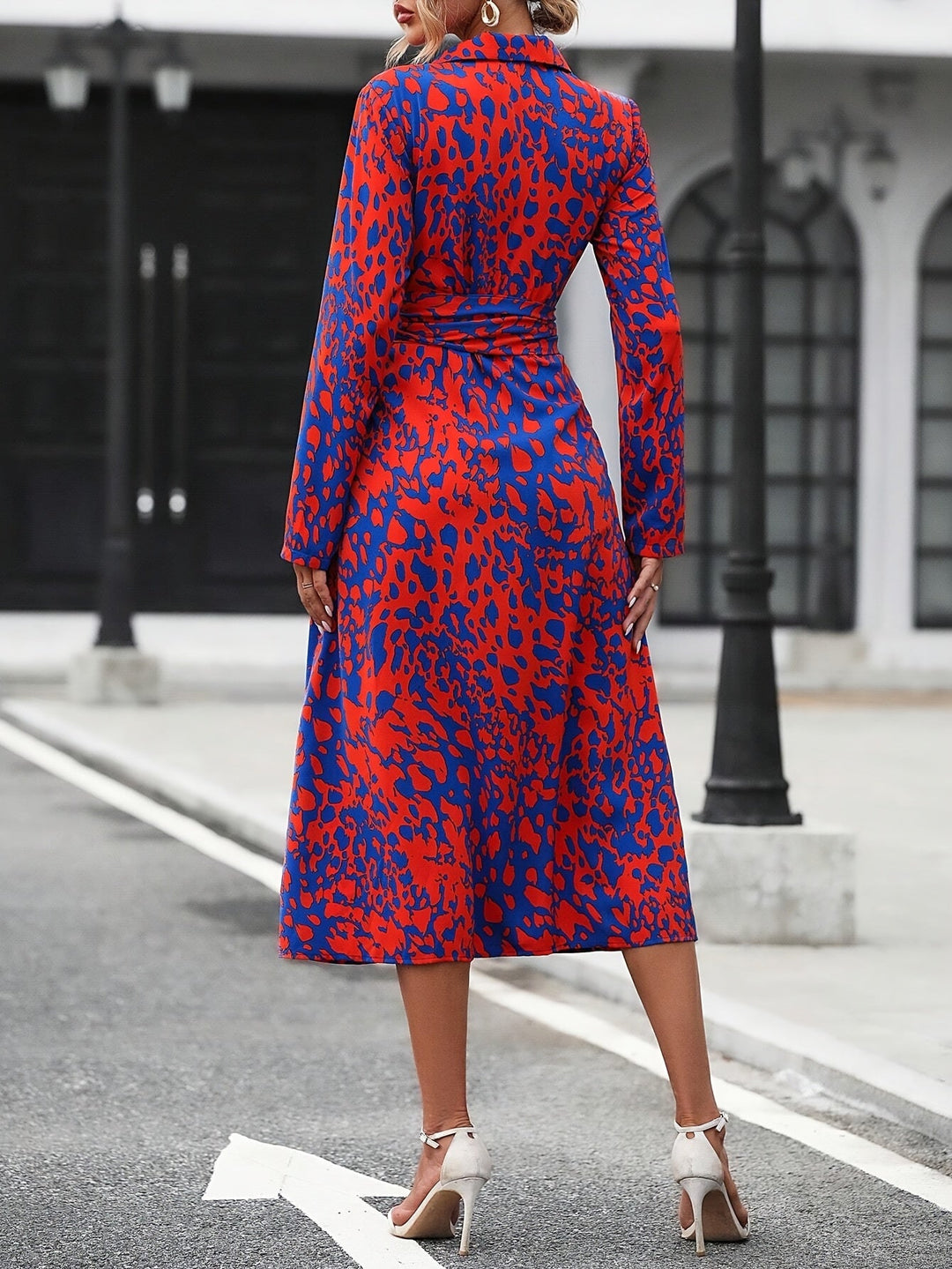 Woman wearing a chic geometric print belted midi shirt dress, perfect for summer.