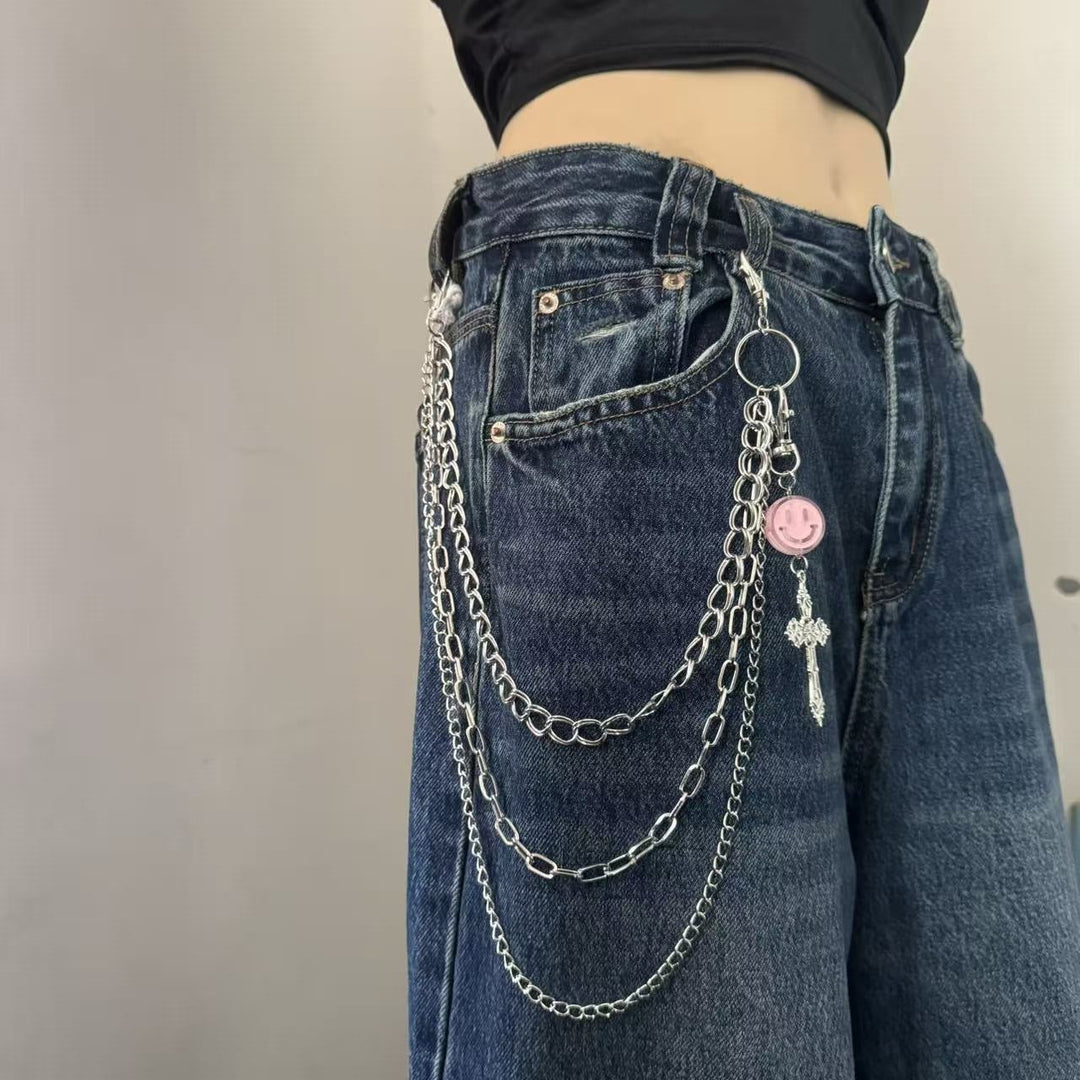 Stylish adjustable women's chain belt featuring diverse charm pendants, a fashionable waist accessory for dresses.