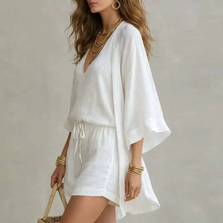 Relaxed fit women's linen co-ord set with V-neck top and drawstring shorts, ideal for beach or vacation wear.