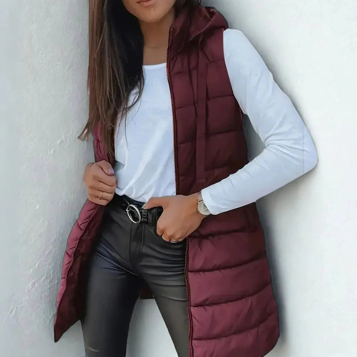 Trendy women's longline hooded puffer vest. Lightweight & sleeveless, essential for modern fall & winter layering.