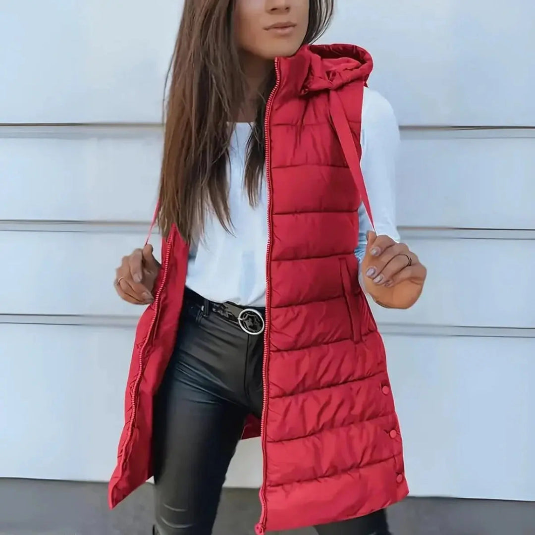 Practical women's longline hooded puffer vest. Lightweight sleeveless jacket for versatile everyday wear & warmth.
