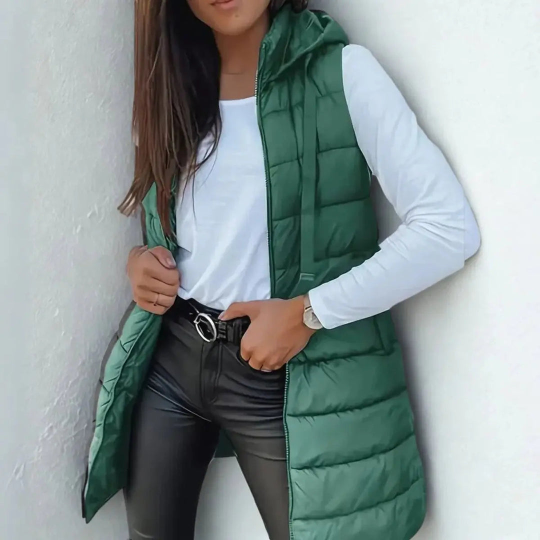 Women's lightweight longline hooded sleeveless puffer vest. Chic outerwear for fall fashion & winter layering.