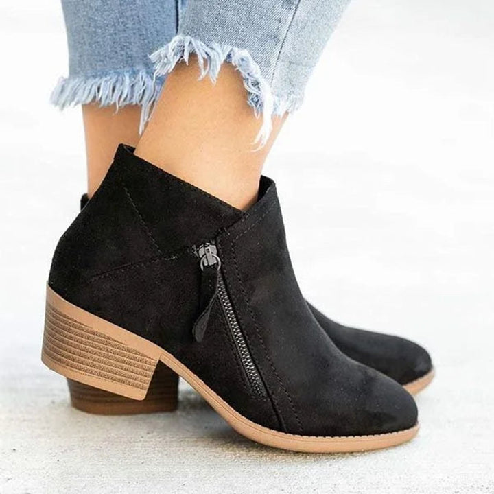 Stylish women's short ankle boots with a practical low heel and side zipper, great for versatile casual outfits.