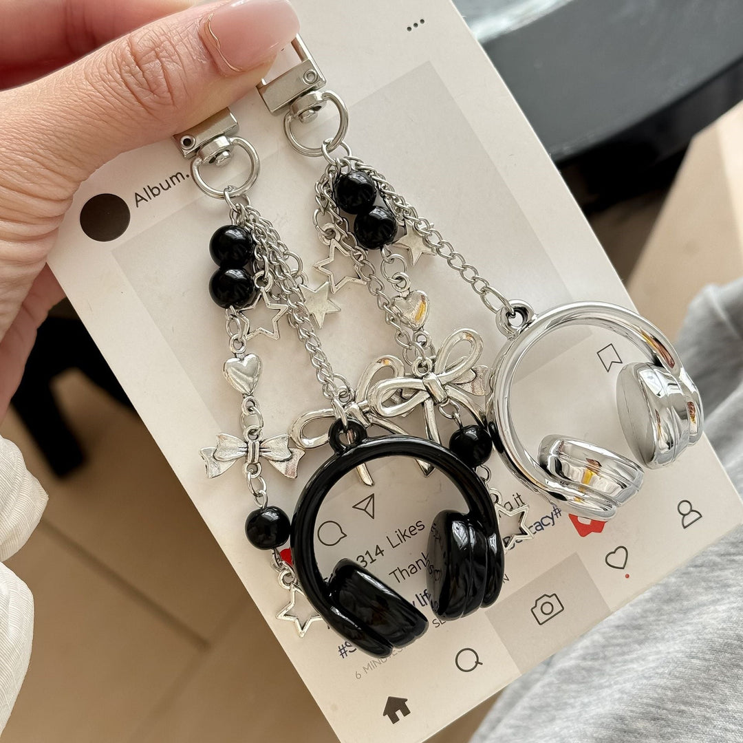 Gold-tone metal headphone charm keychain with intricate details, perfect for women's bags.