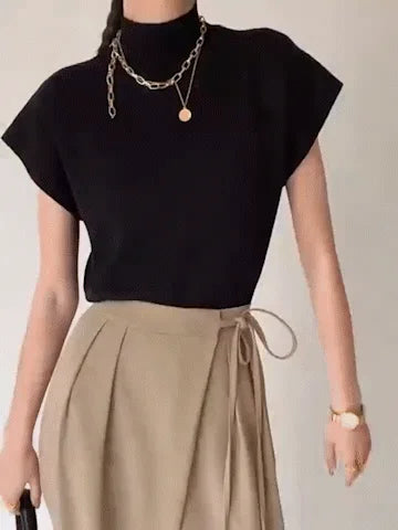 Sophisticated women's mock-neck top, cap sleeves & padded shoulders. Elegant fashion choice.