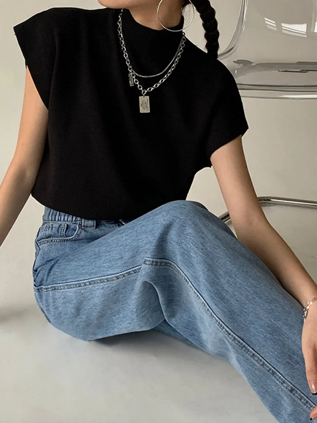 Modern women's mock-neck sweater, padded shoulders, cap sleeves. Versatile and chic.