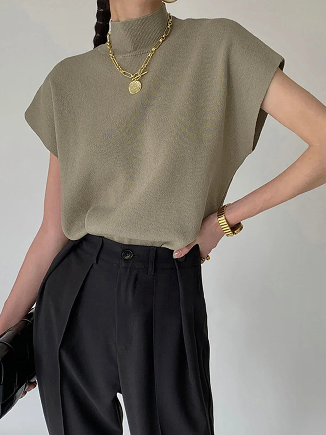 Chic women's mock-neck top, padded shoulders, cap sleeves. A sophisticated everyday sweater.