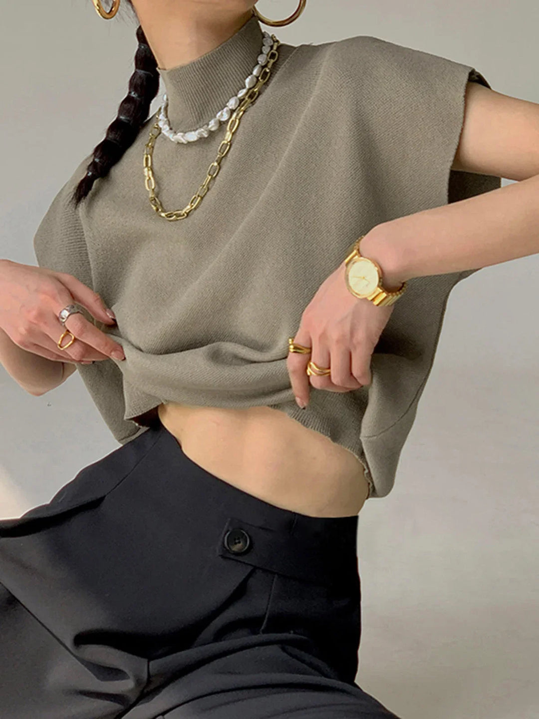 Women's versatile mock-neck top, padded shoulders, cap sleeves. Modern, elegant design.
