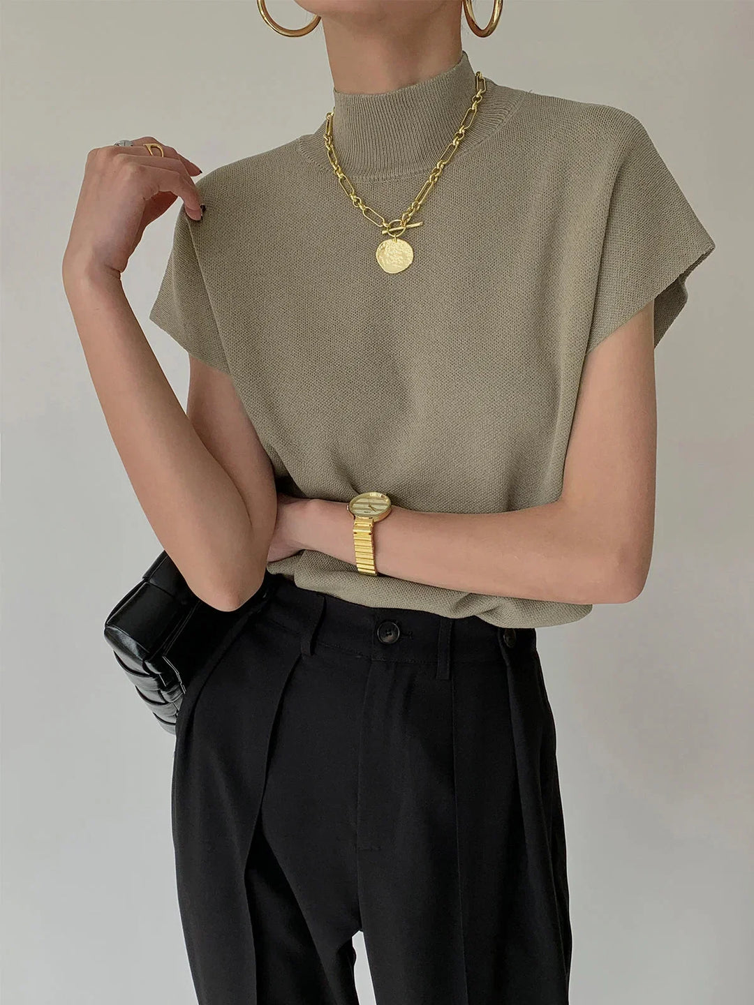Elegant women's mock-neck sweater, padded shoulders, cap sleeves. Perfect for layering.