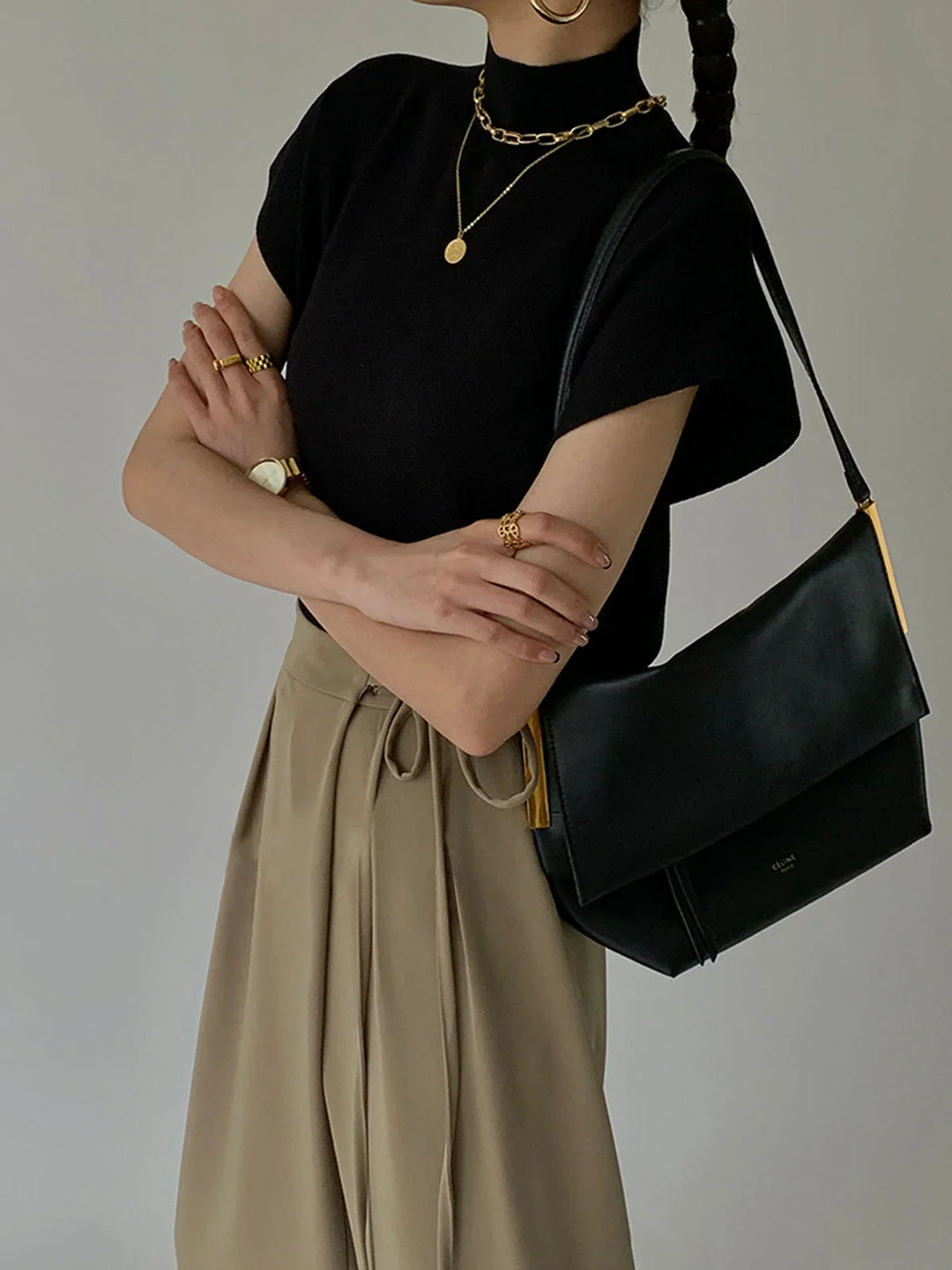 Fashionable women's mock-neck sweater with padded shoulders & cap sleeves. Chic & stylish.