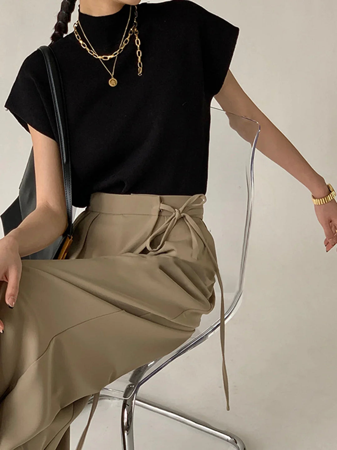 Women's chic mock-neck top, padded shoulders, cap-sleeves. Modern style, versatile everyday.