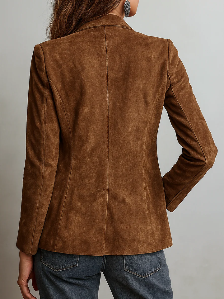 Close-up of women's professional notch lapel blazer. Elegant button-down closure & long sleeves.