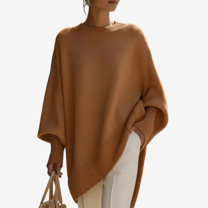 Chic women's oversized batwing sleeve sweater featuring an asymmetric hem, a versatile autumn fashion staple.