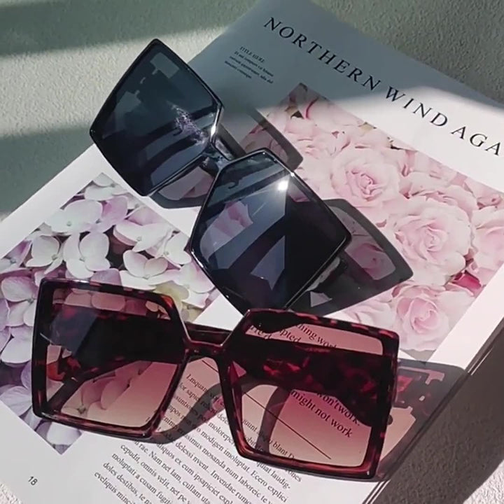 Women's chic oversized fashion sunglasses, black frame, UV protection for a stylish look.