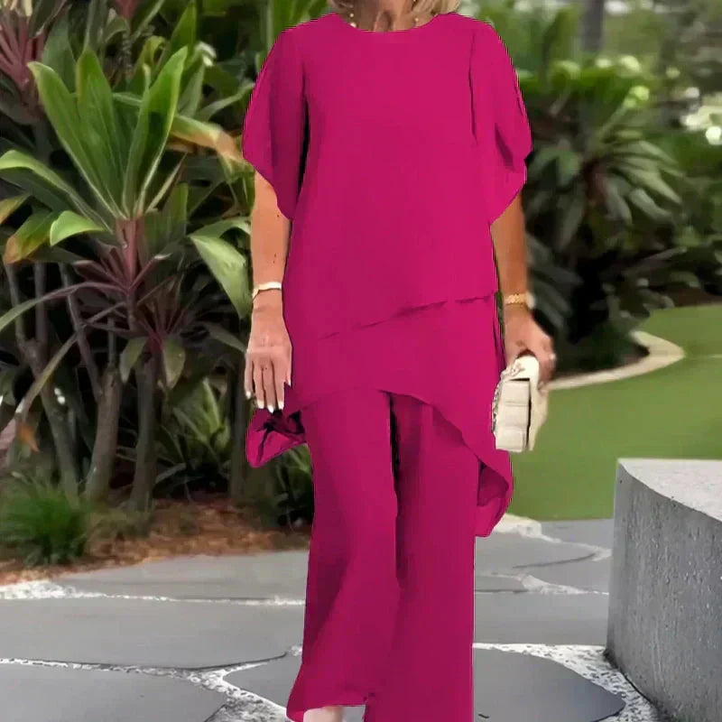 Elegant women's two-piece outfit, featuring a chic layered top and wide-leg trousers.
