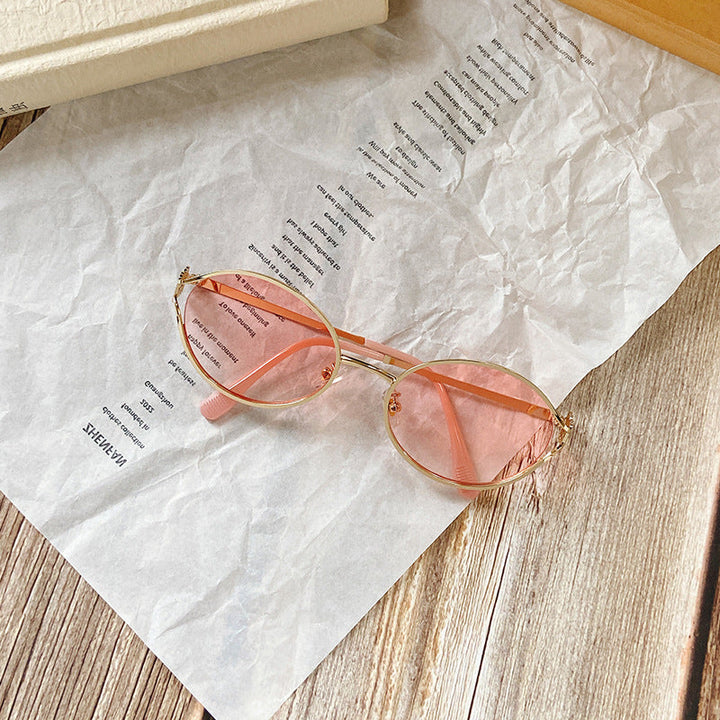 Classic round women's sunglasses with subtle gold accents, ideal for any fashion-forward look.