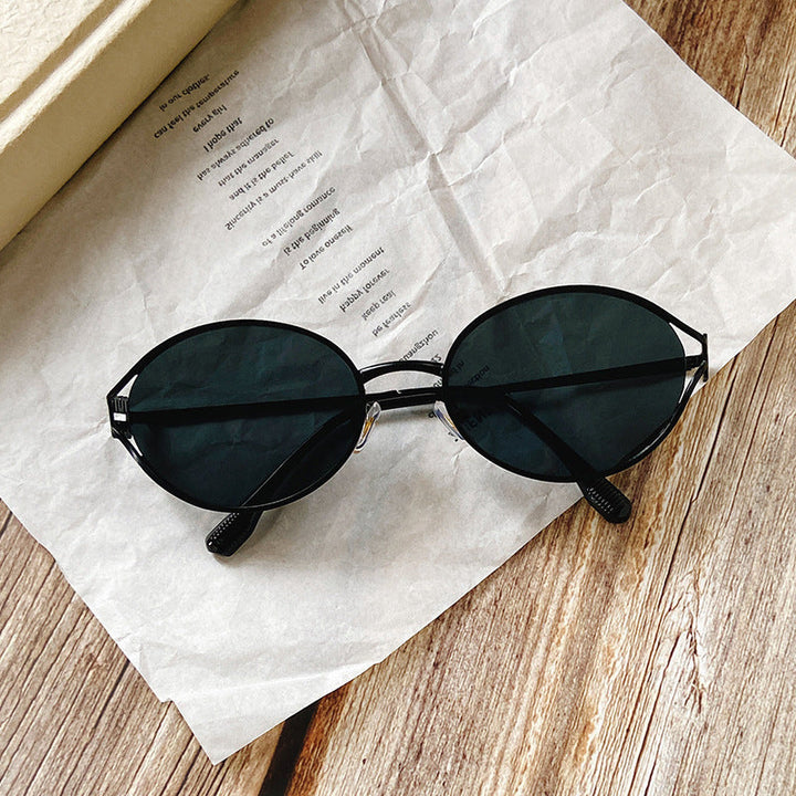 Front view of women's chic round sunglasses, highlighting the sophisticated gold accents.