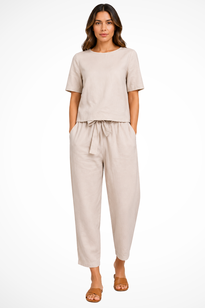 Stylish women's short sleeve crop top paired with comfortable tapered trousers for a trendy two-piece summer set.