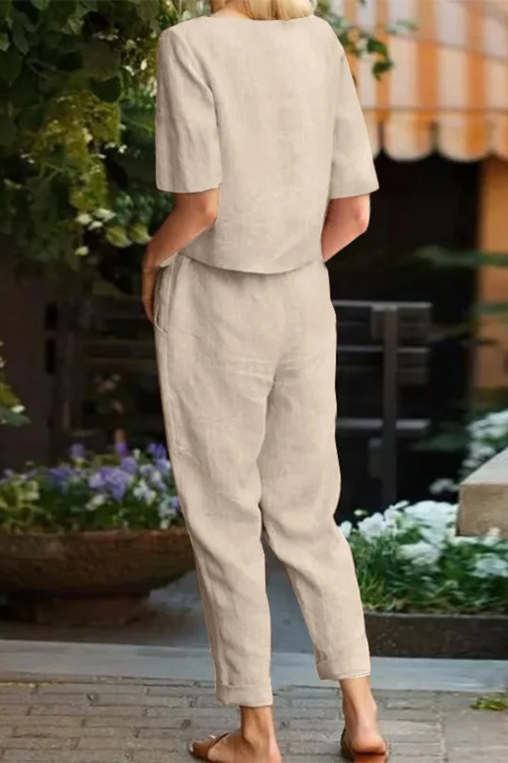 Chic women's two-piece set, a short sleeve crop top & tapered trousers, suitable for semi-formal or elegant casual wear.