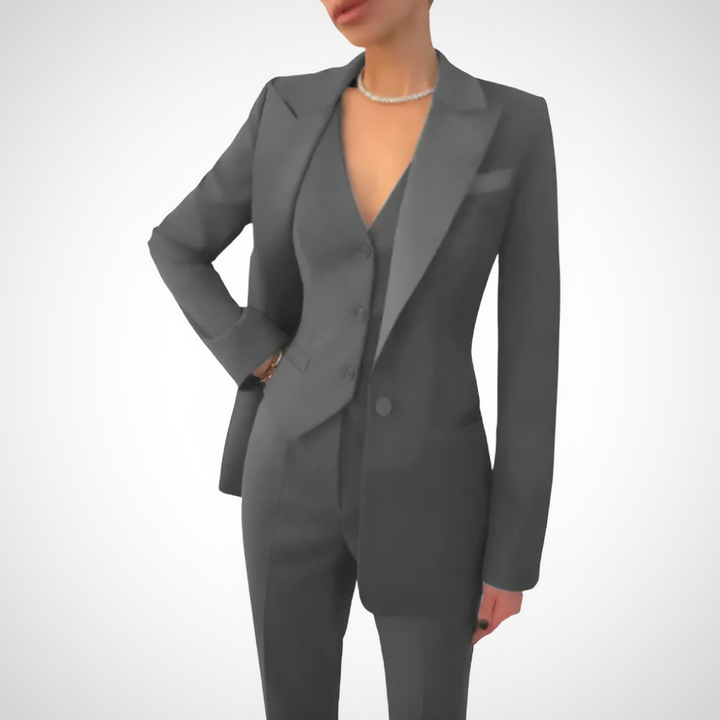Womenswear tailored three-piece suit featuring a stylish blazer, fitted vest & sleek trousers. Ideal formal attire.