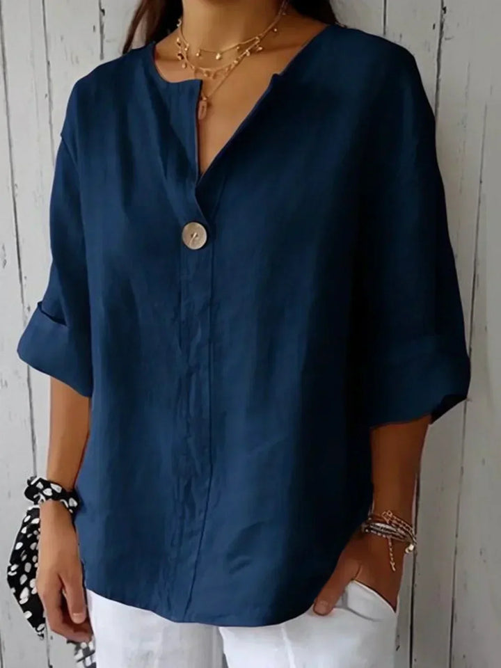 Relaxed fit women's V-neck blouse with roll sleeves, a stylish button-down top for spring and summer comfort.