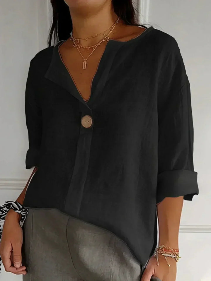 Elegant women's V-neck button-down blouse featuring adjustable roll sleeves, a perfect spring/summer top.