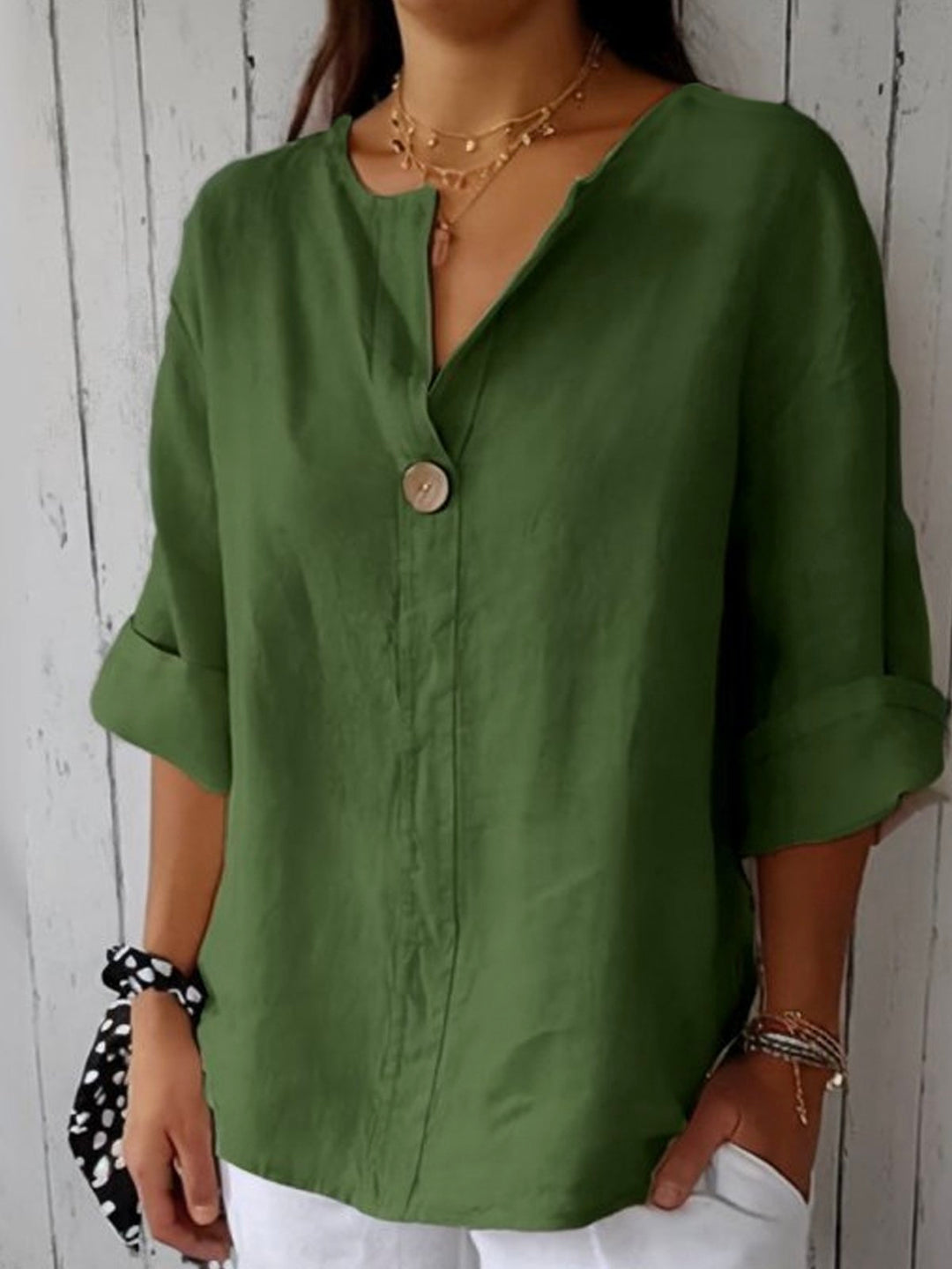 Comfortable women's button-down V-neck blouse with roll sleeves, suitable for casual or office outfits.