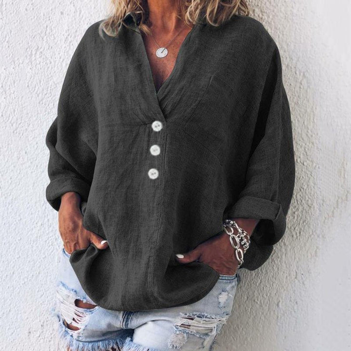 Black women's V-neck long sleeve blouse with button front. Oversized fit top, ideal for casual everyday wear.
