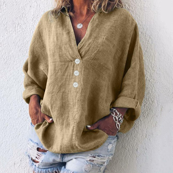 Stylish blue V-neck long sleeve blouse for women. Oversized fit, comfortable and versatile for casual elegance.