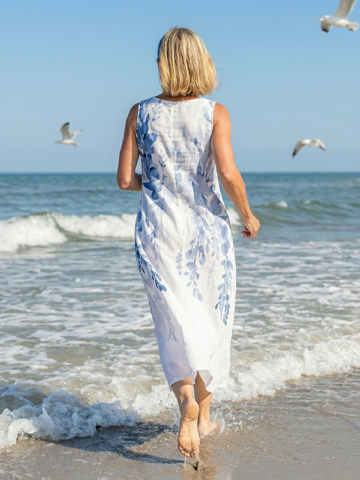 Women's relaxed fit sleeveless maxi dress in white with botanical print. Great for summer, beach, and comfortable style.