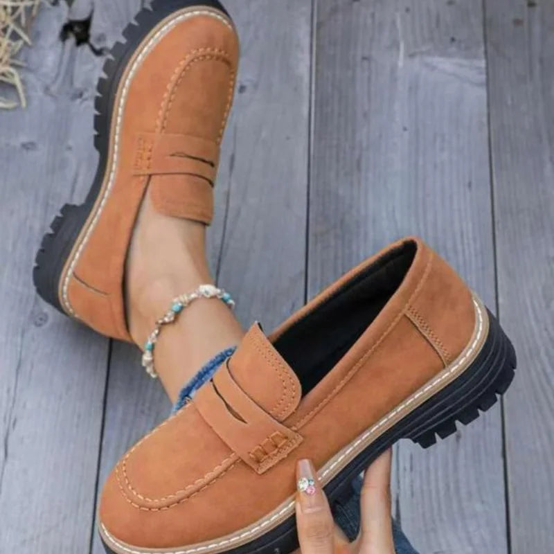 Stylish women's footwear: chunky platform loafers with a practical slip-on design and distinctive penny strap.