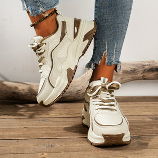 Chunky platform women's sneakers featuring a panelled design. Stylish and comfortable footwear for trendsetters.