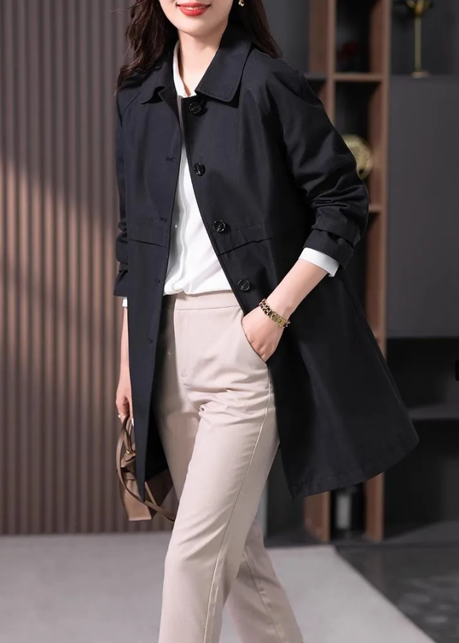 Women's classic black short trench coat with single button closure, ideal for spring and fall outerwear.