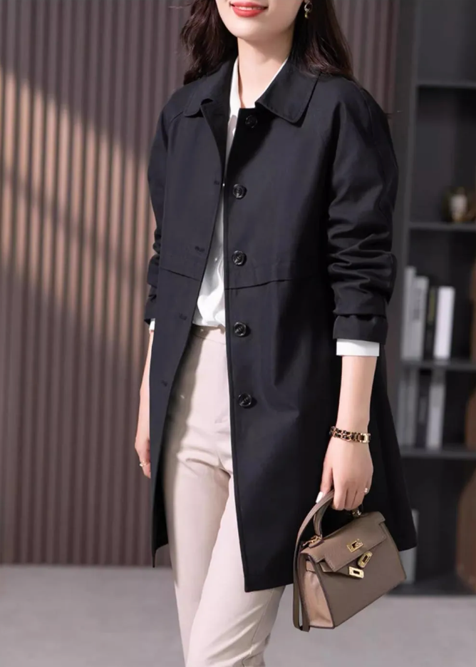 Effortless women's black short trench coat, a must-have fall/spring outerwear piece for any wardrobe.
