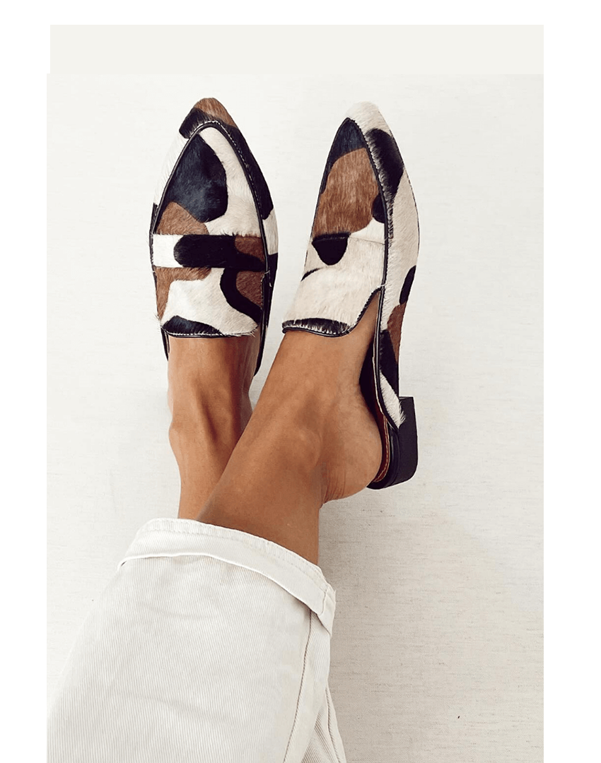 Women's classic black & white patterned slip-on loafers. Chic, comfortable flats for stylish everyday elegance.
