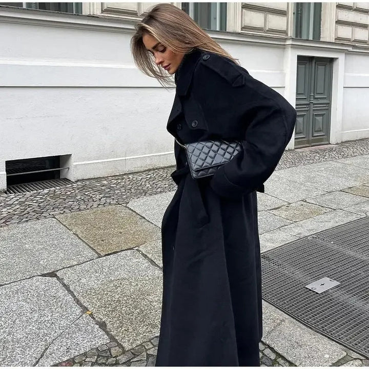 Elegant women's long trench coat, double-breasted design with belted waist for sophisticated fall fashion.